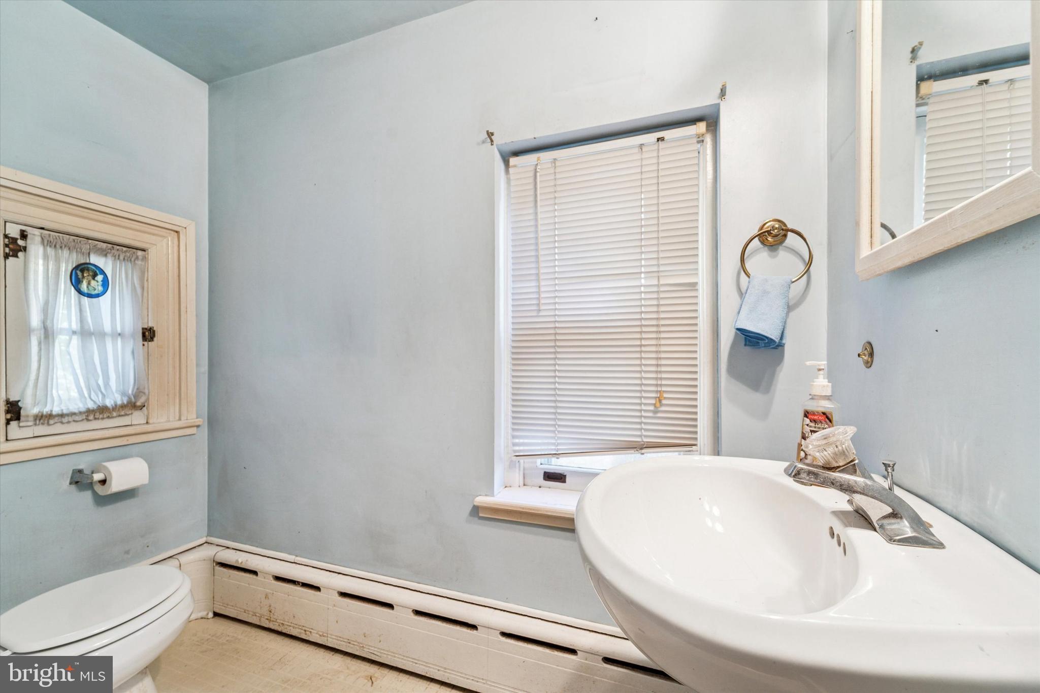 2546 North Broad Street Colmar, PA 19446 - Photo 5 of 25 a bathroom with a sink a toilet and a window