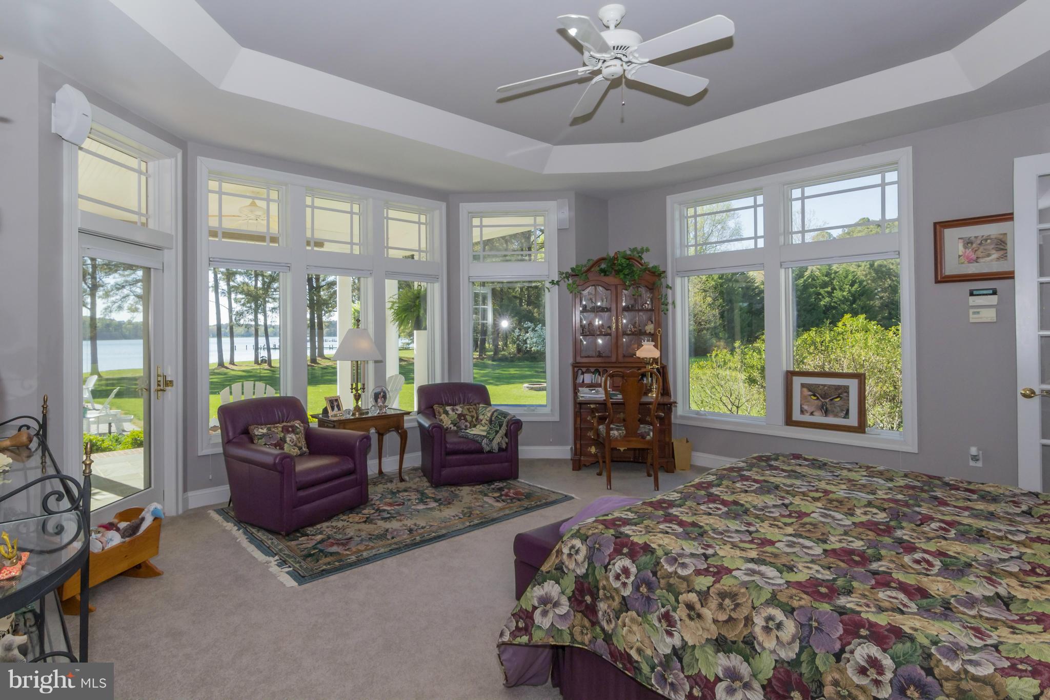 8092 Church Neck Road St. Michaels, MD 21663 - Photo 14 of 27 a bedroom with a bed and large windows