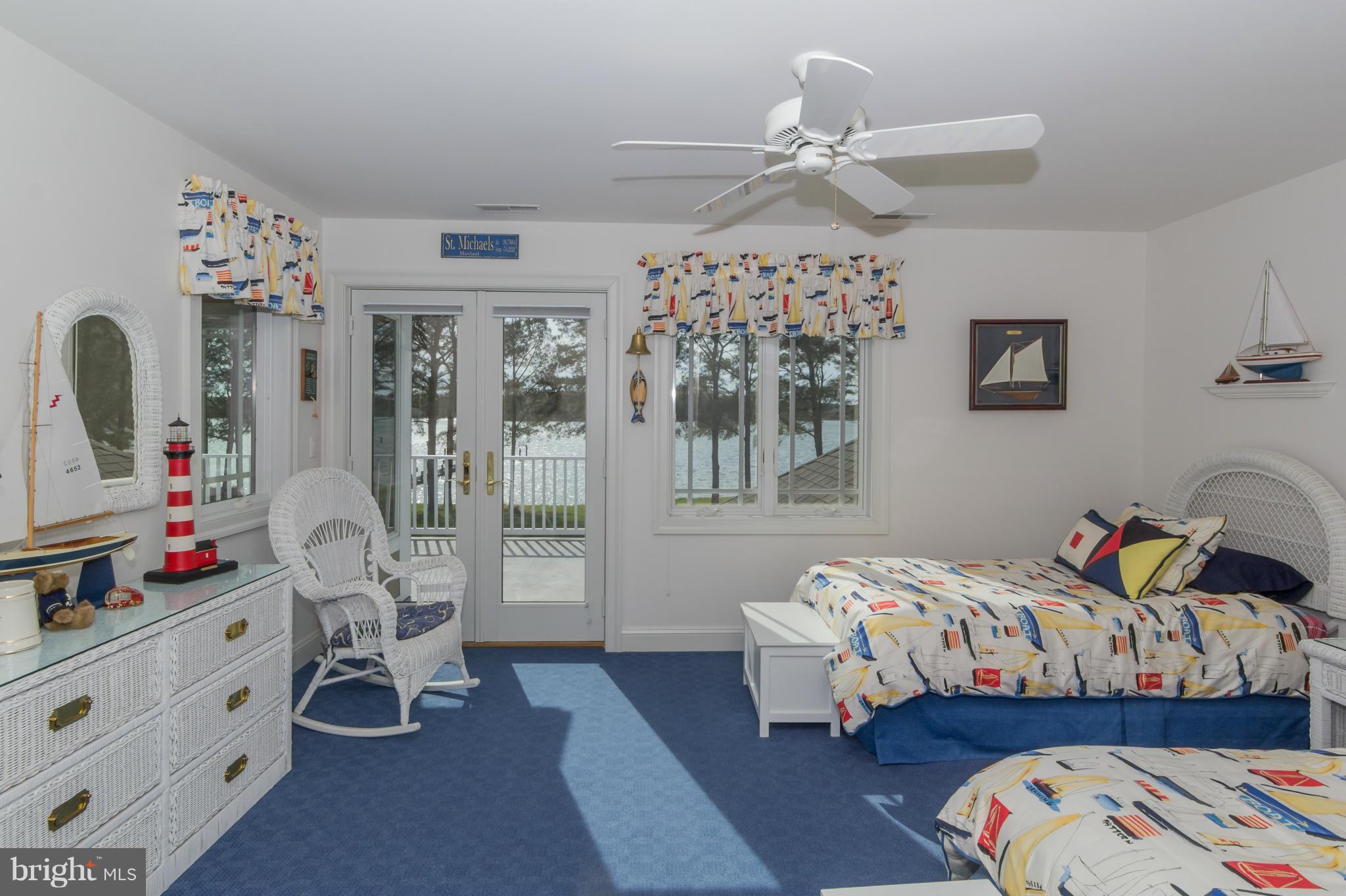 8092 Church Neck Road St. Michaels, MD 21663 - Photo 19 of 27 a bedroom with bed and a chandelier