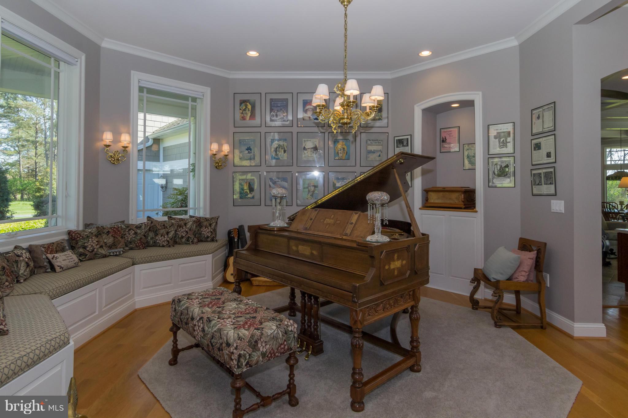 8092 Church Neck Road St. Michaels, MD 21663 - Photo 6 of 27 a living room with furniture a dining table and a chandelier