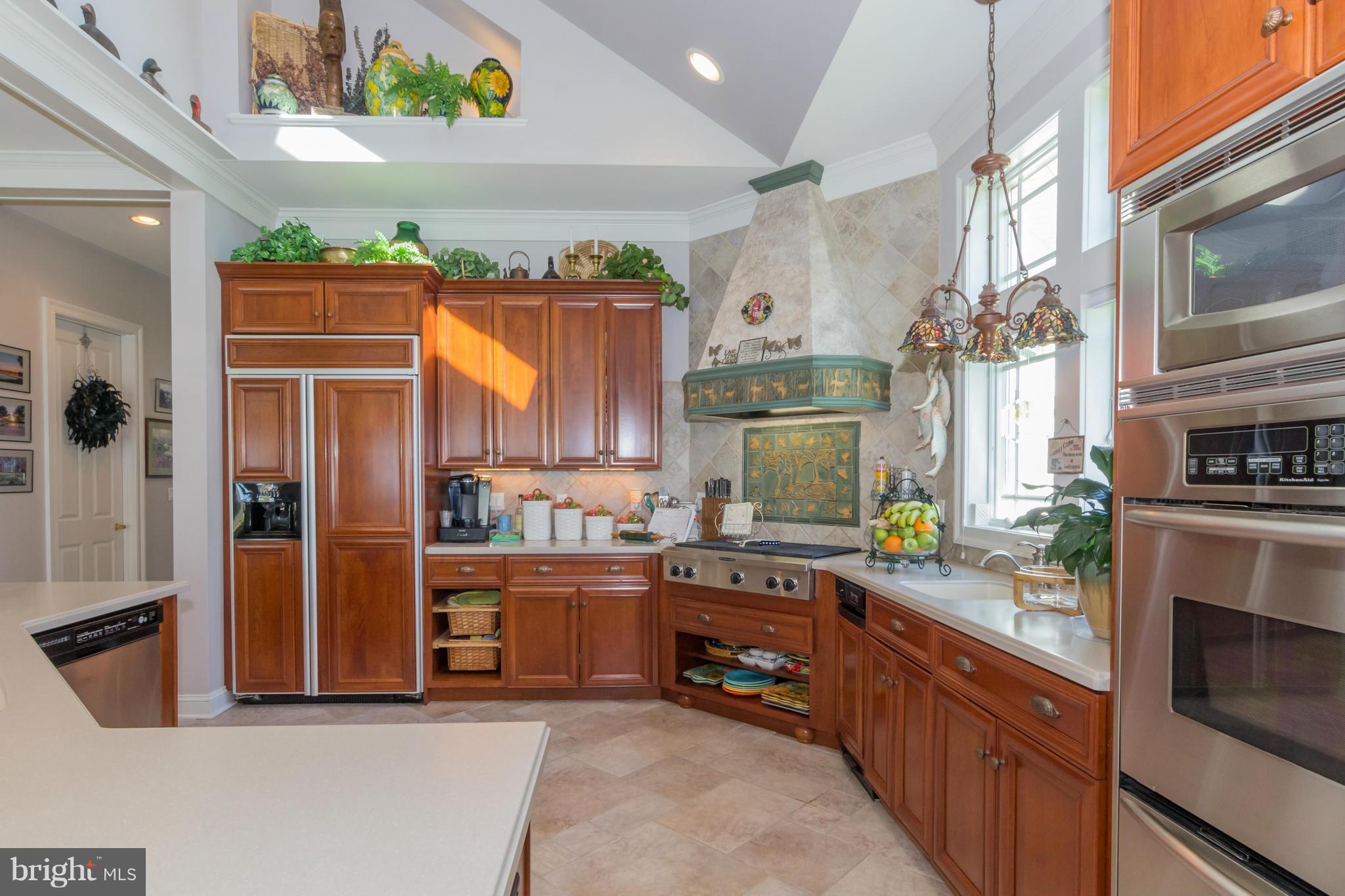 8092 Church Neck Road St. Michaels, MD 21663 - Photo 10 of 27 a kitchen with stainless steel appliances granite countertop a stove a sink and a refrigerator