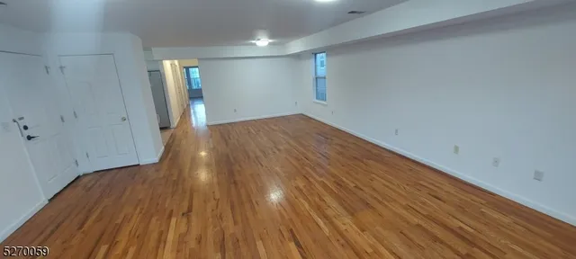 a view of hallway with wooden floor