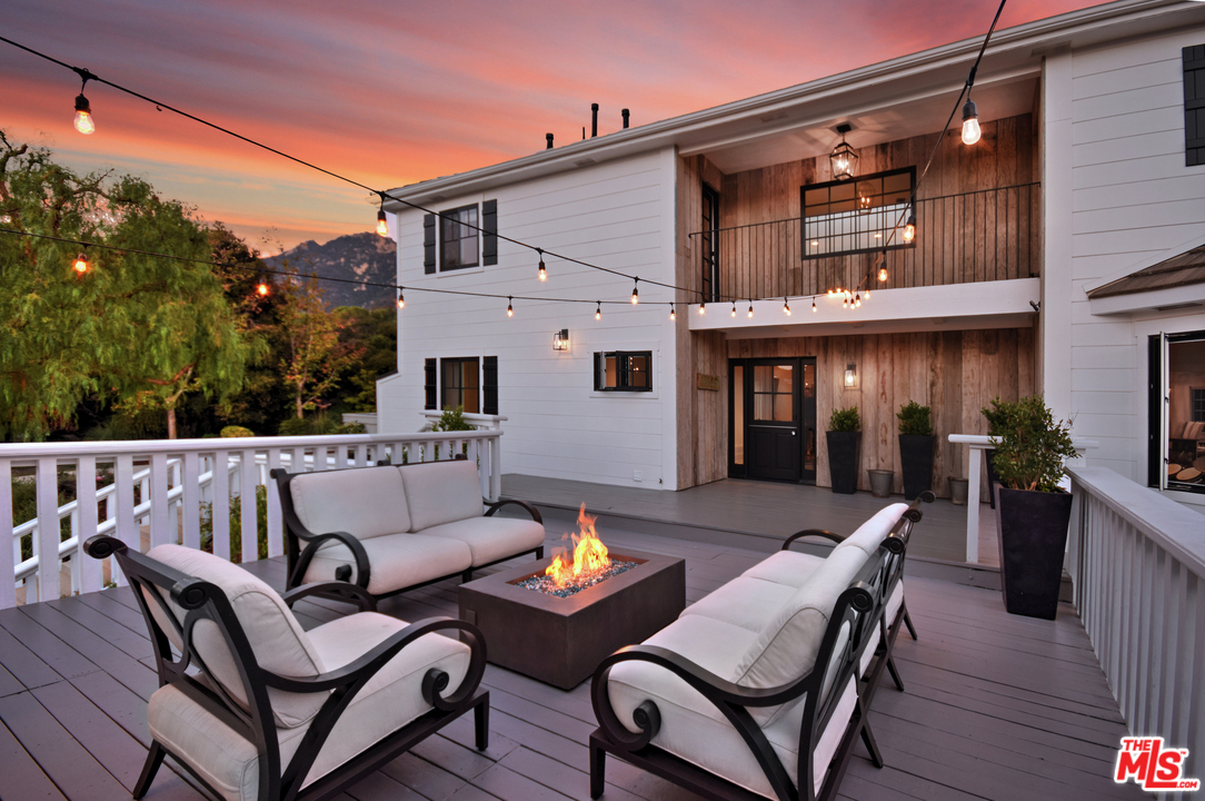560 Cold Canyon Road Calabasas, CA 91302 - Photo 1 of 38 a roof deck with a table and chairs