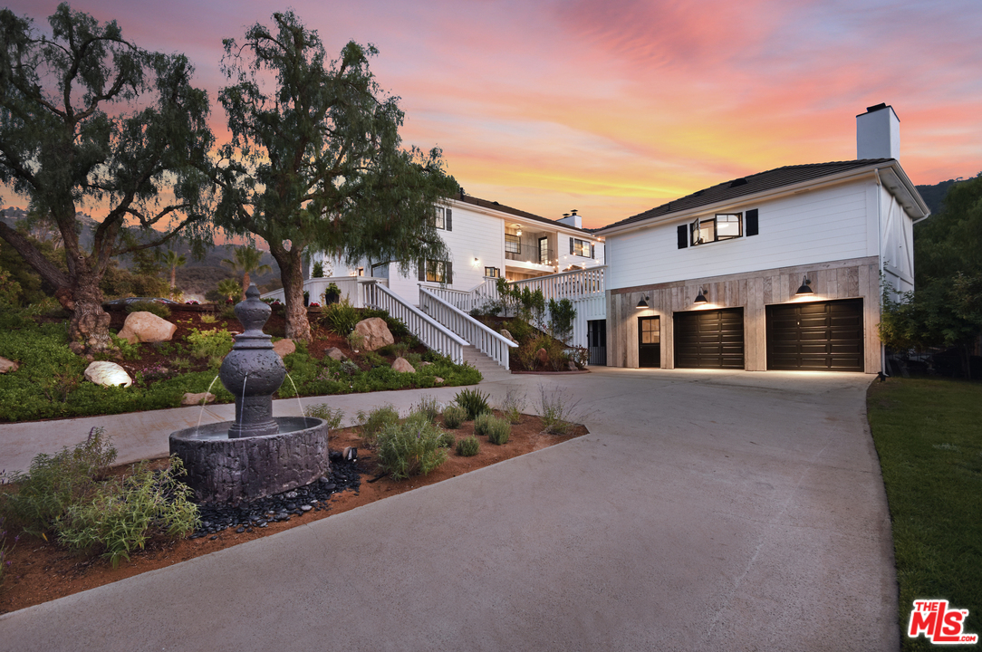 560 Cold Canyon Road Calabasas, CA 91302 - Photo 2 of 38 a front view of a house with a yard