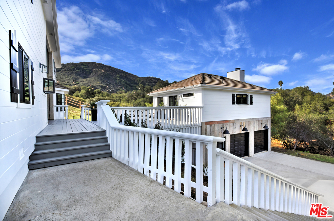 560 Cold Canyon Road Calabasas, CA 91302 - Photo 11 of 38 a view of a house with wooden fence