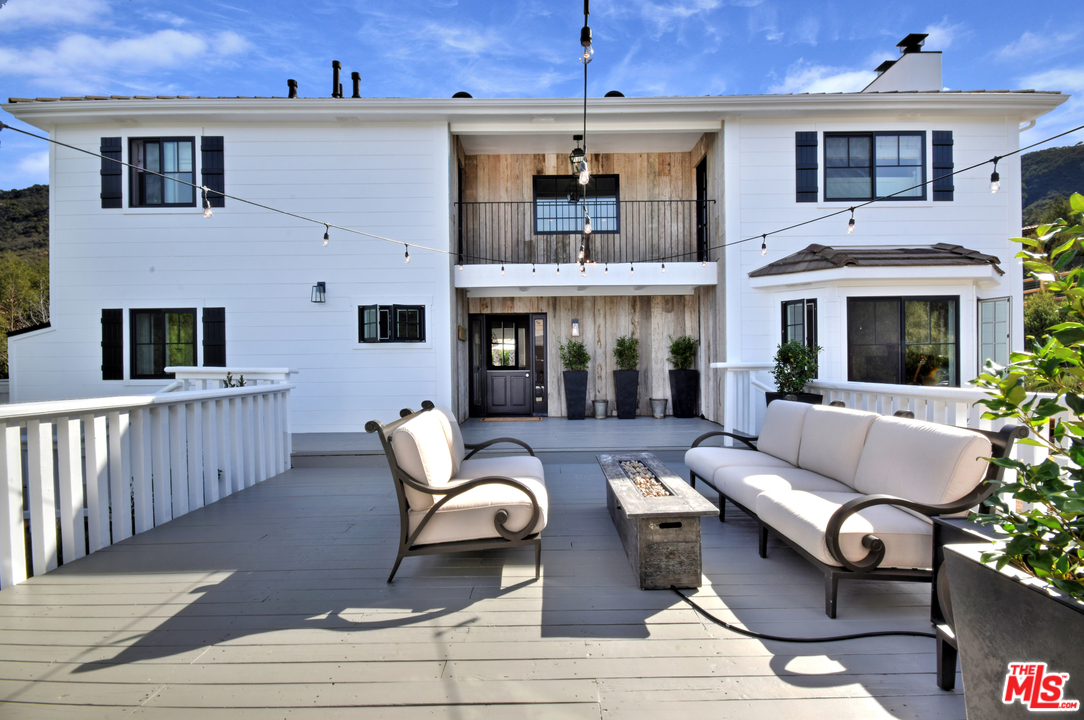 560 Cold Canyon Road Calabasas, CA 91302 - Photo 12 of 38 a view of a patio with couches chairs and wooden floor