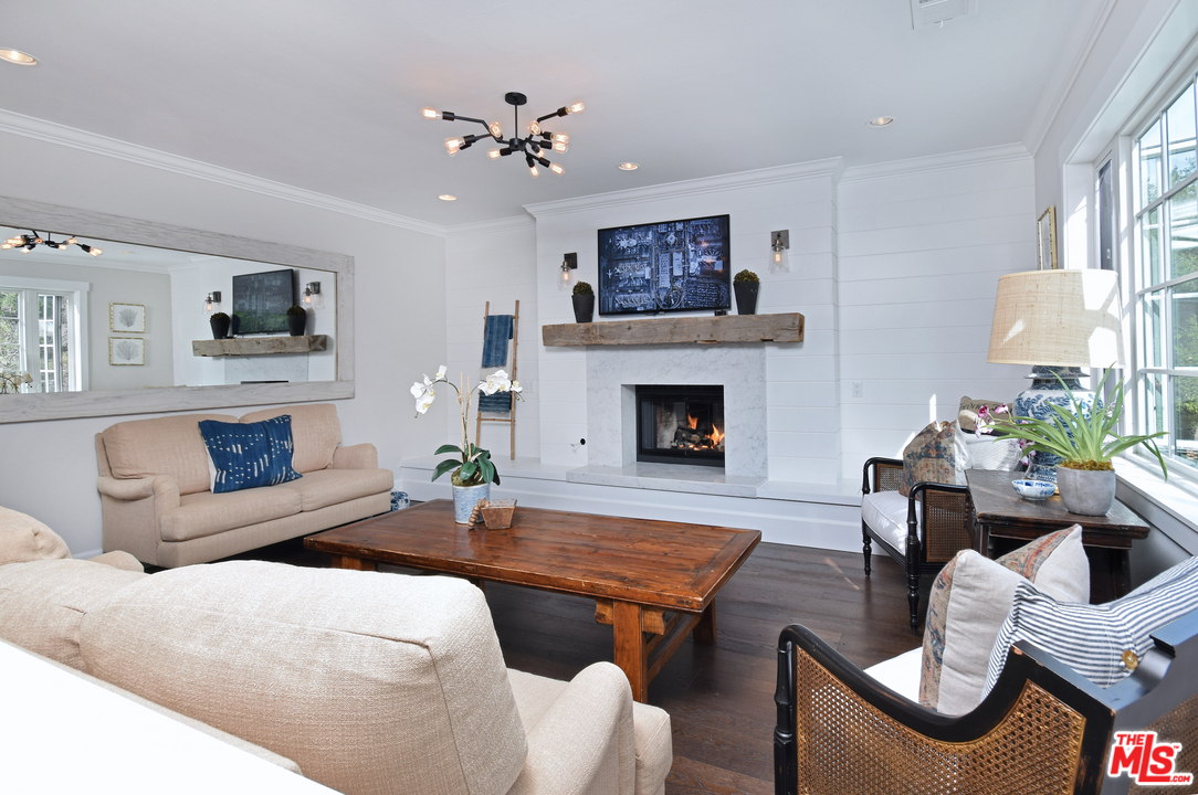 560 Cold Canyon Road Calabasas, CA 91302 - Photo 14 of 38 a living room with furniture a flat screen tv and a fireplace