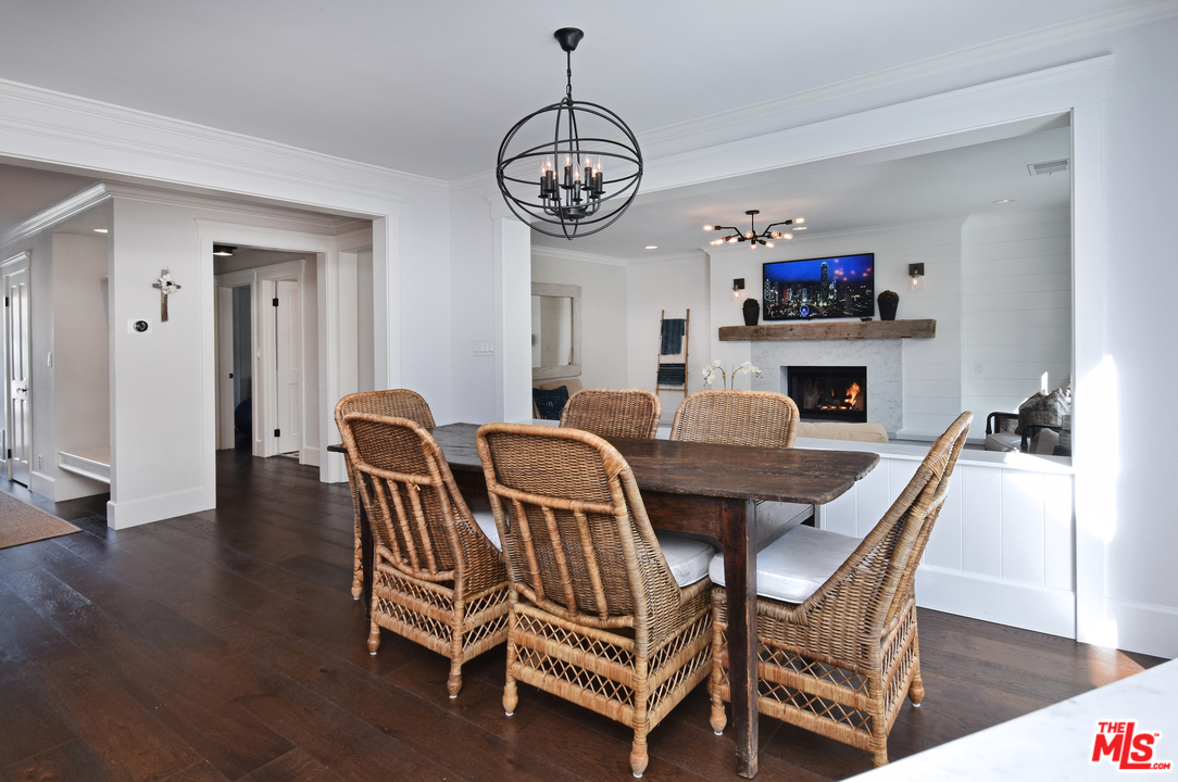 560 Cold Canyon Road Calabasas, CA 91302 - Photo 15 of 38 a view of a dining room with furniture wooden floor and a chandelier