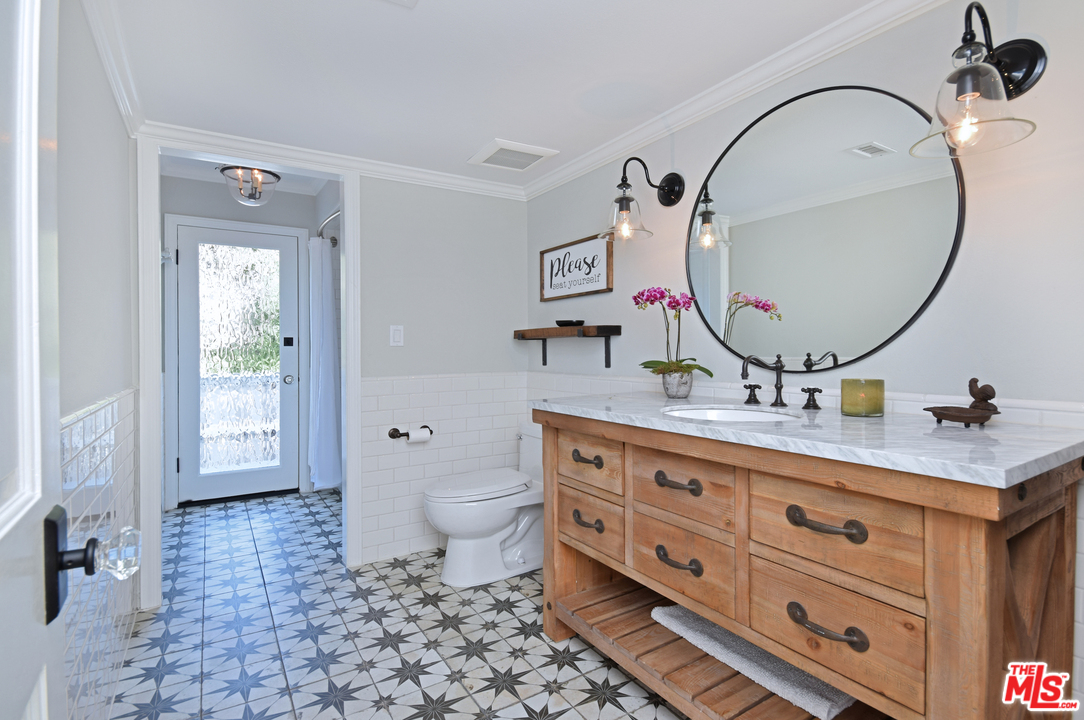 560 Cold Canyon Road Calabasas, CA 91302 - Photo 20 of 38 a bathroom with a double vanity sink mirror and toilet