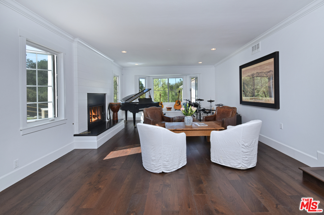 560 Cold Canyon Road Calabasas, CA 91302 - Photo 21 of 38 a living room with couches and a coffee table with wooden floor