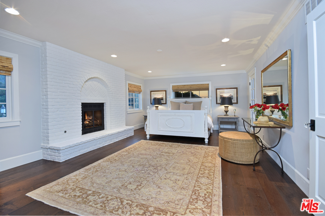 560 Cold Canyon Road Calabasas, CA 91302 - Photo 22 of 38 a living room with furniture and a fireplace