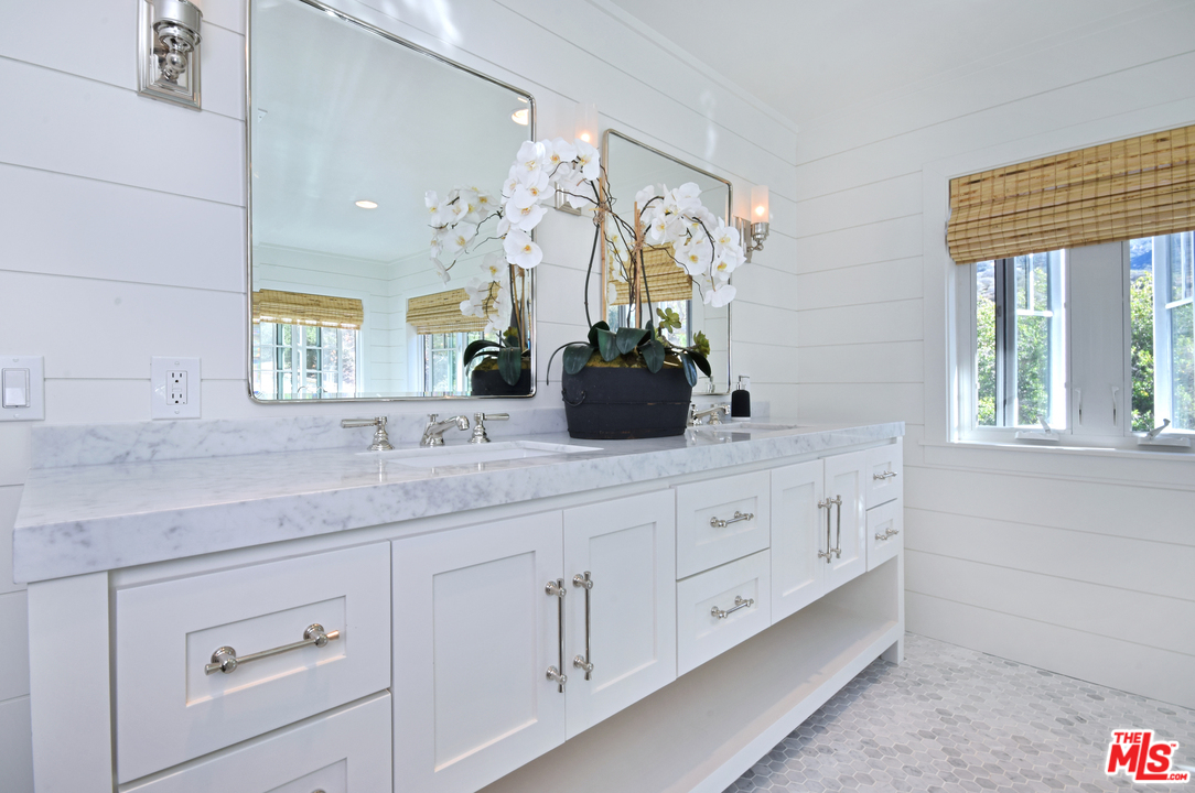 560 Cold Canyon Road Calabasas, CA 91302 - Photo 23 of 38 a bathroom with a granite countertop sink mirror and window