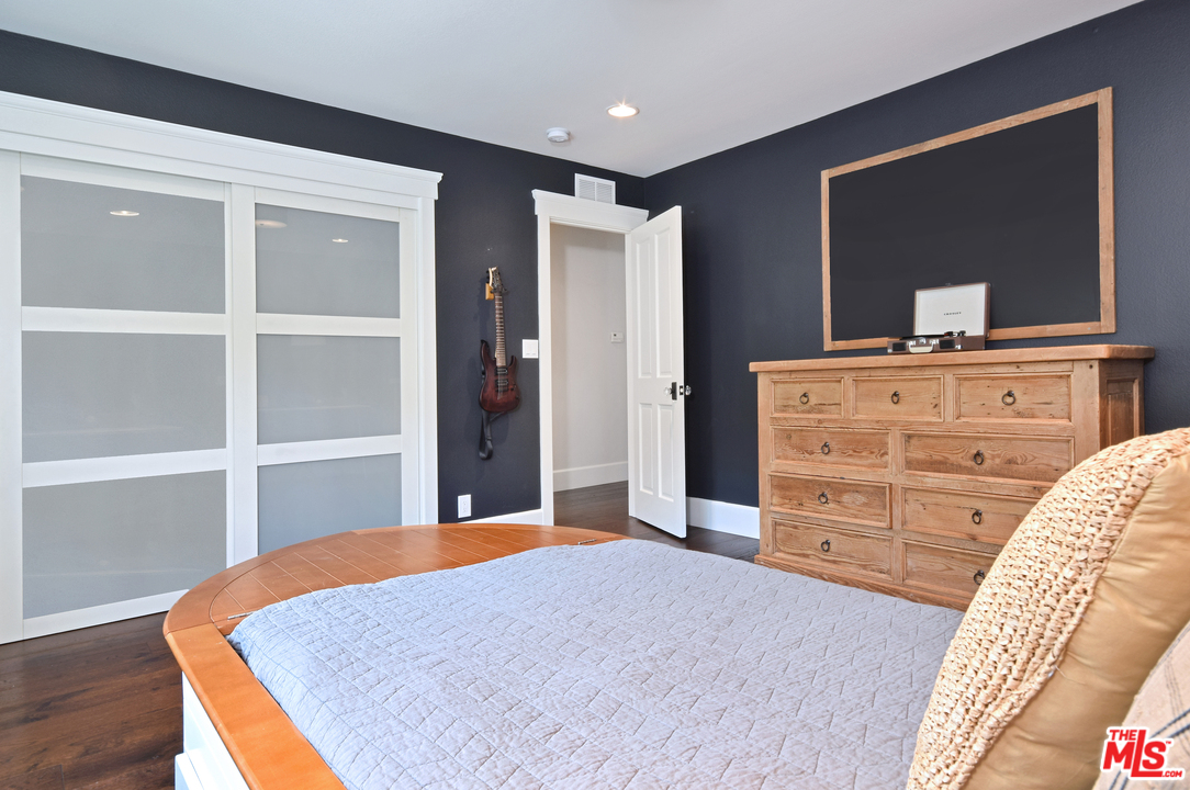 560 Cold Canyon Road Calabasas, CA 91302 - Photo 25 of 38 a bedroom with a bed and a dresser