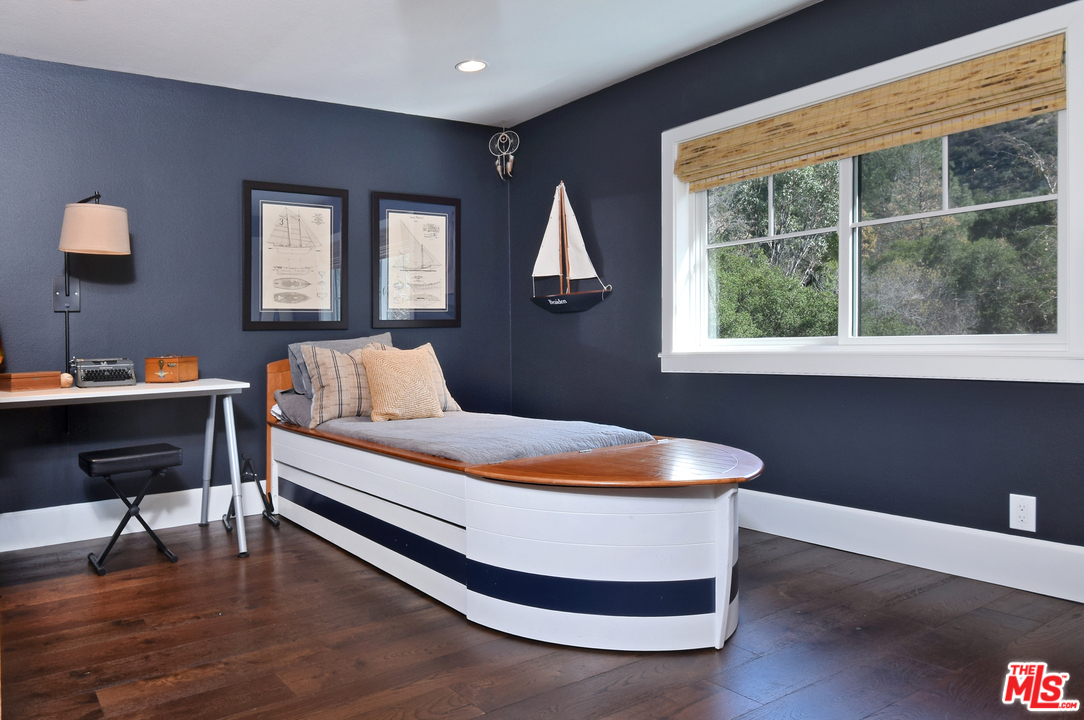 560 Cold Canyon Road Calabasas, CA 91302 - Photo 26 of 38 a bedroom with a bed and a window