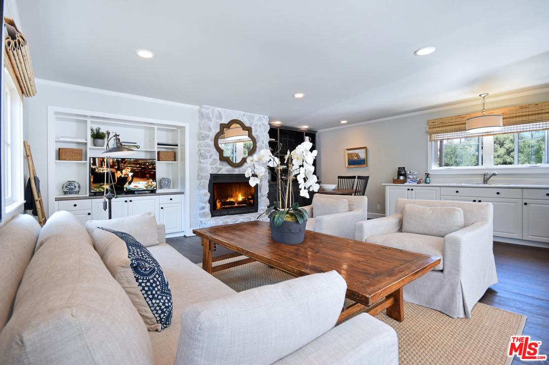 560 Cold Canyon Road Calabasas, CA 91302 - Photo 31 of 38 a living room with furniture a fireplace and a large window