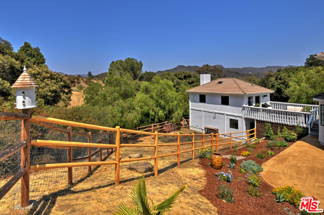 560 Cold Canyon Road Calabasas, CA 91302 - Photo 32 of 38 a view of a balcony with chairs and wooden fence
