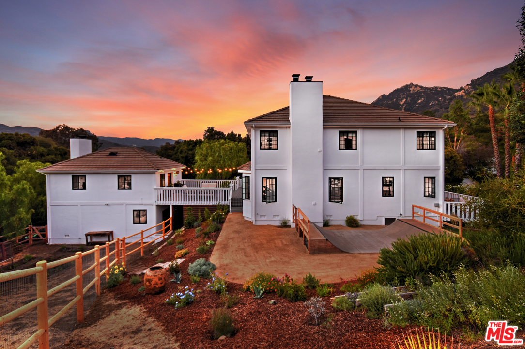560 Cold Canyon Road Calabasas, CA 91302 - Photo 36 of 38 a front view of a house with a yard