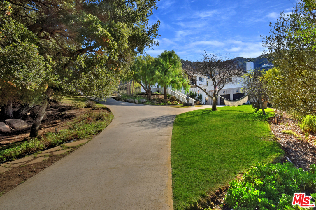 560 Cold Canyon Road Calabasas, CA 91302 - Photo 9 of 38 a view of a garden with a house