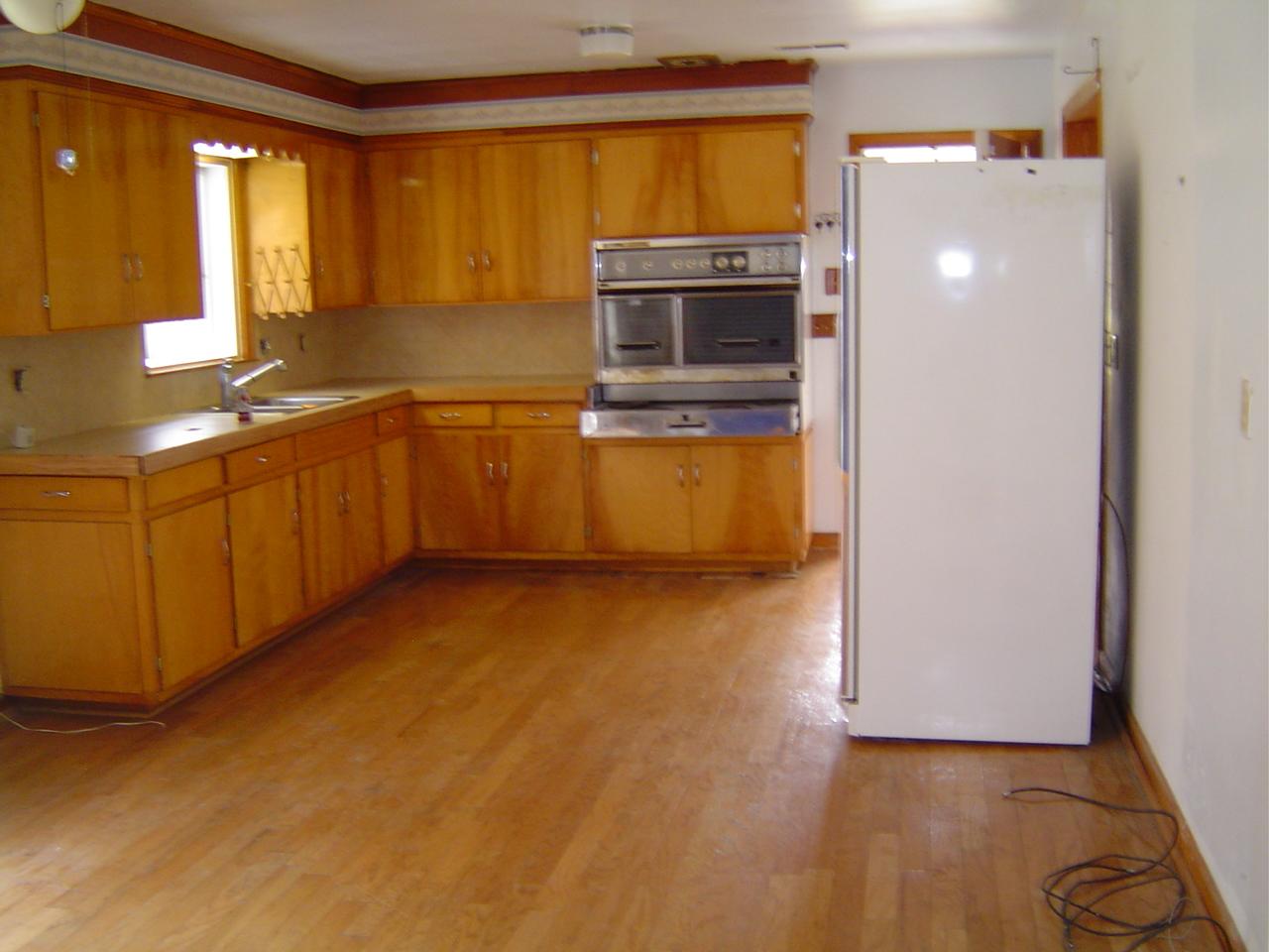 410 Brake Road Elliston, VA 24087 - Photo 7 of 14 a kitchen with stainless steel appliances a stove a microwave and a hard wood floor