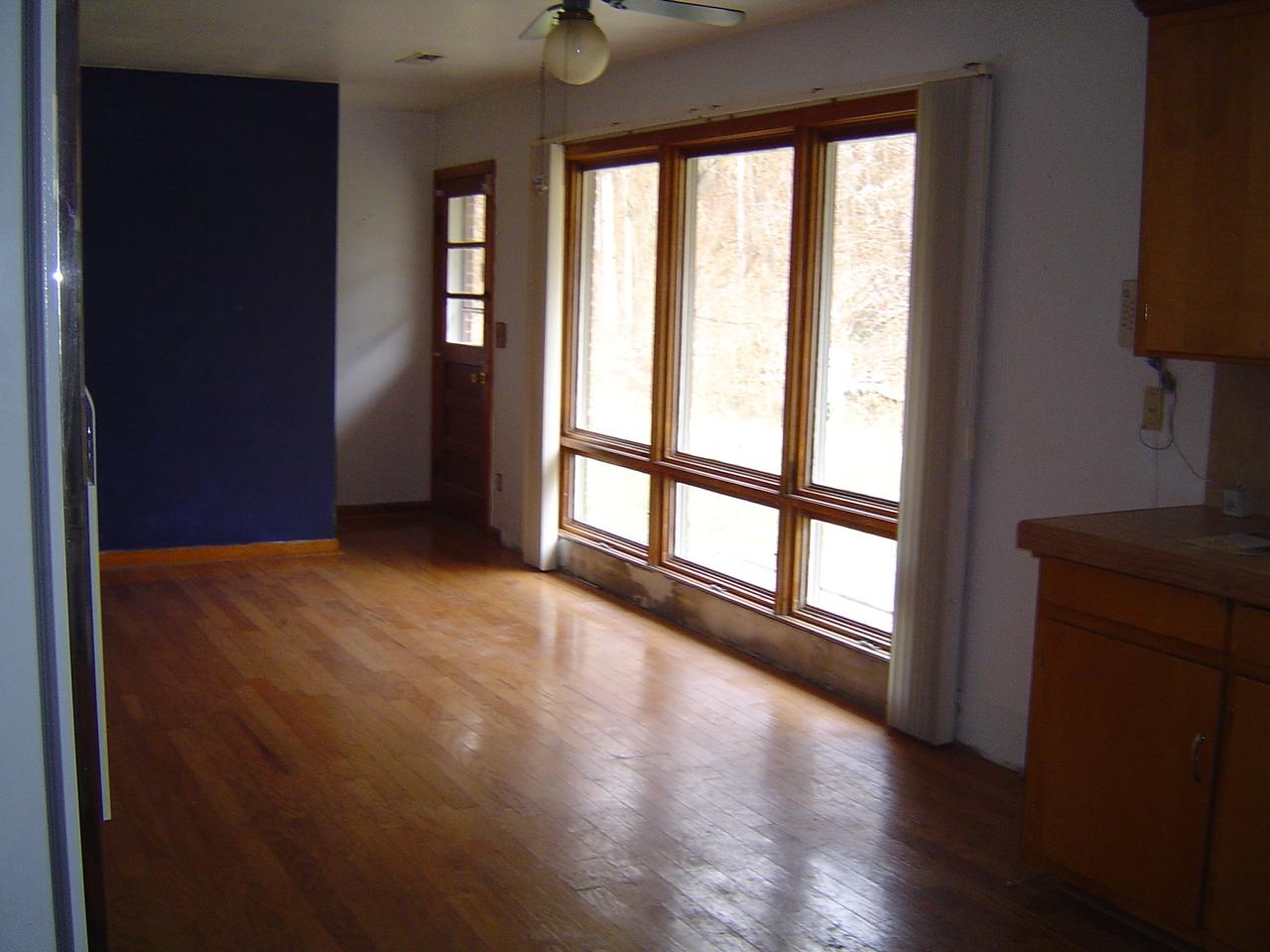 410 Brake Road Elliston, VA 24087 - Photo 8 of 14 an empty room with wooden floor and windows