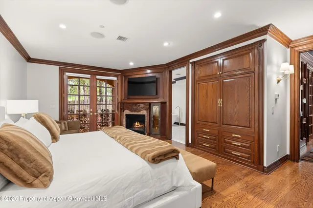 a spacious bedroom with a large bed and a dresser