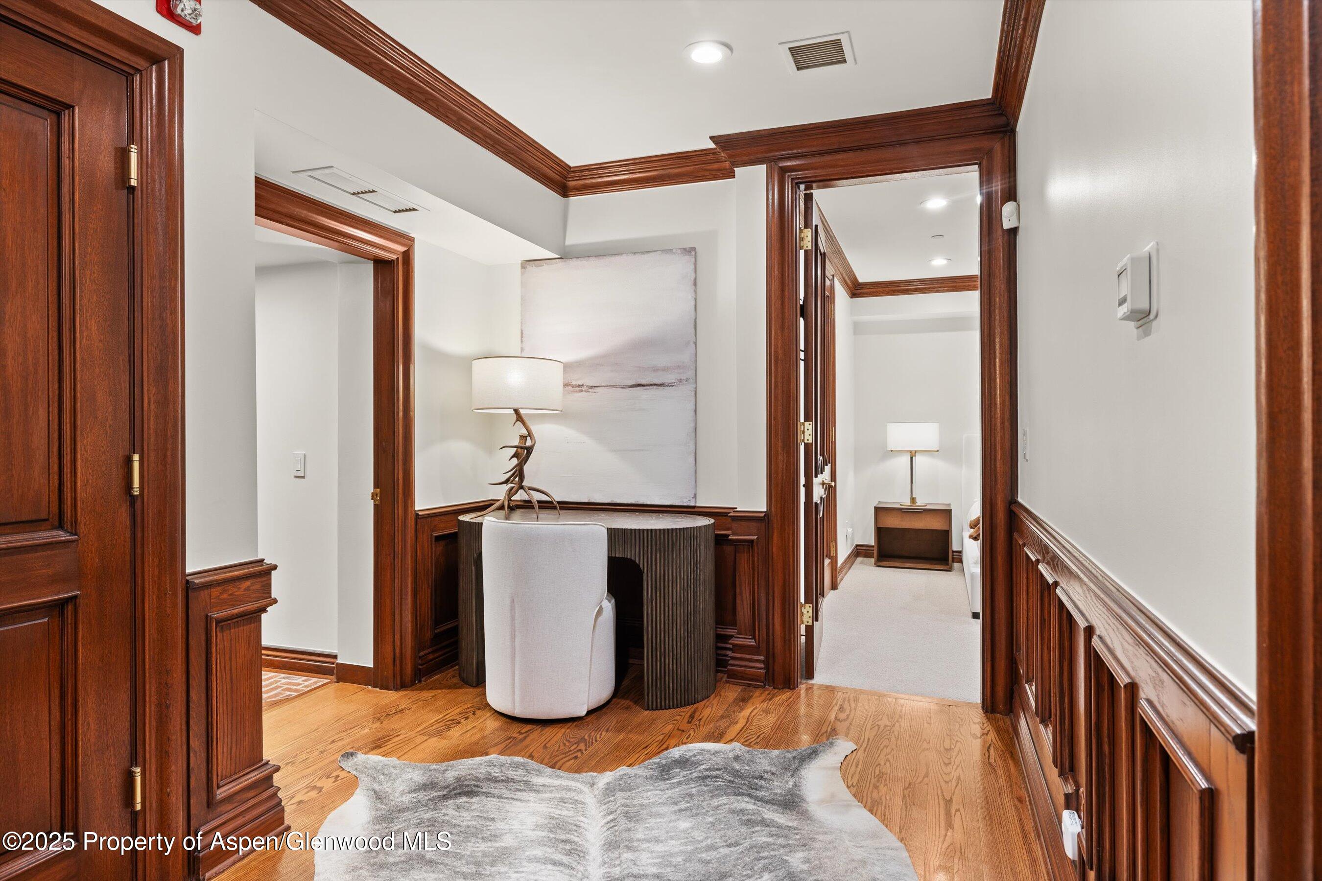 918 South Mill Street, Unit A Aspen, CO 81611 - Photo 17 of 34 a view of a hallway with wooden floor and staircase
