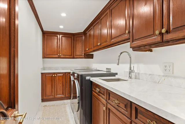 a kitchen with stainless steel appliances granite countertop a sink a stove and cabinets