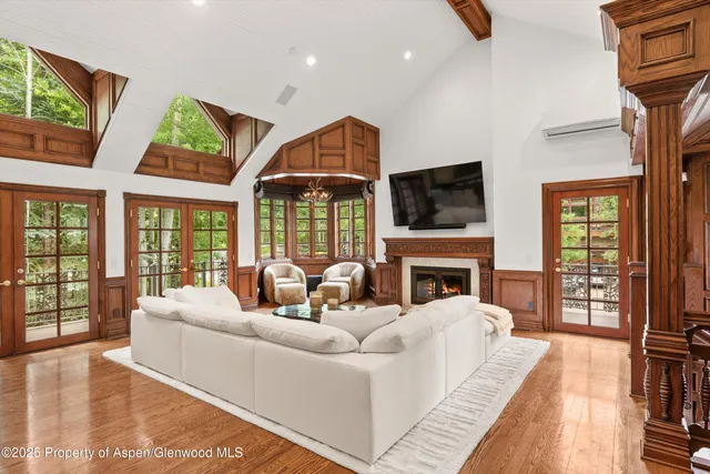 a living room with fireplace furniture and a flat screen tv
