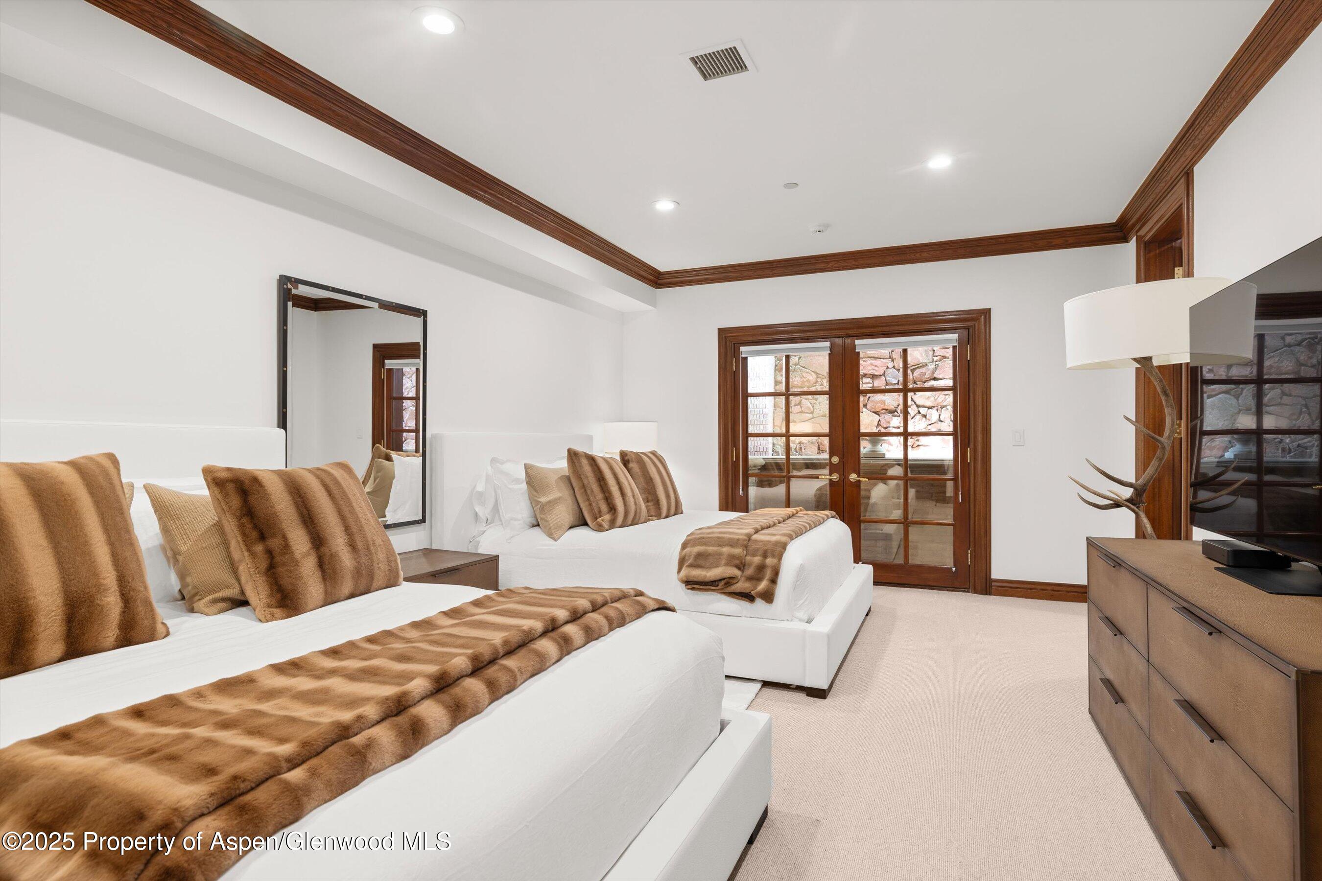 918 South Mill Street, Unit A Aspen, CO 81611 - Photo 21 of 34 a bedroom with a large bed and a flat tv screen