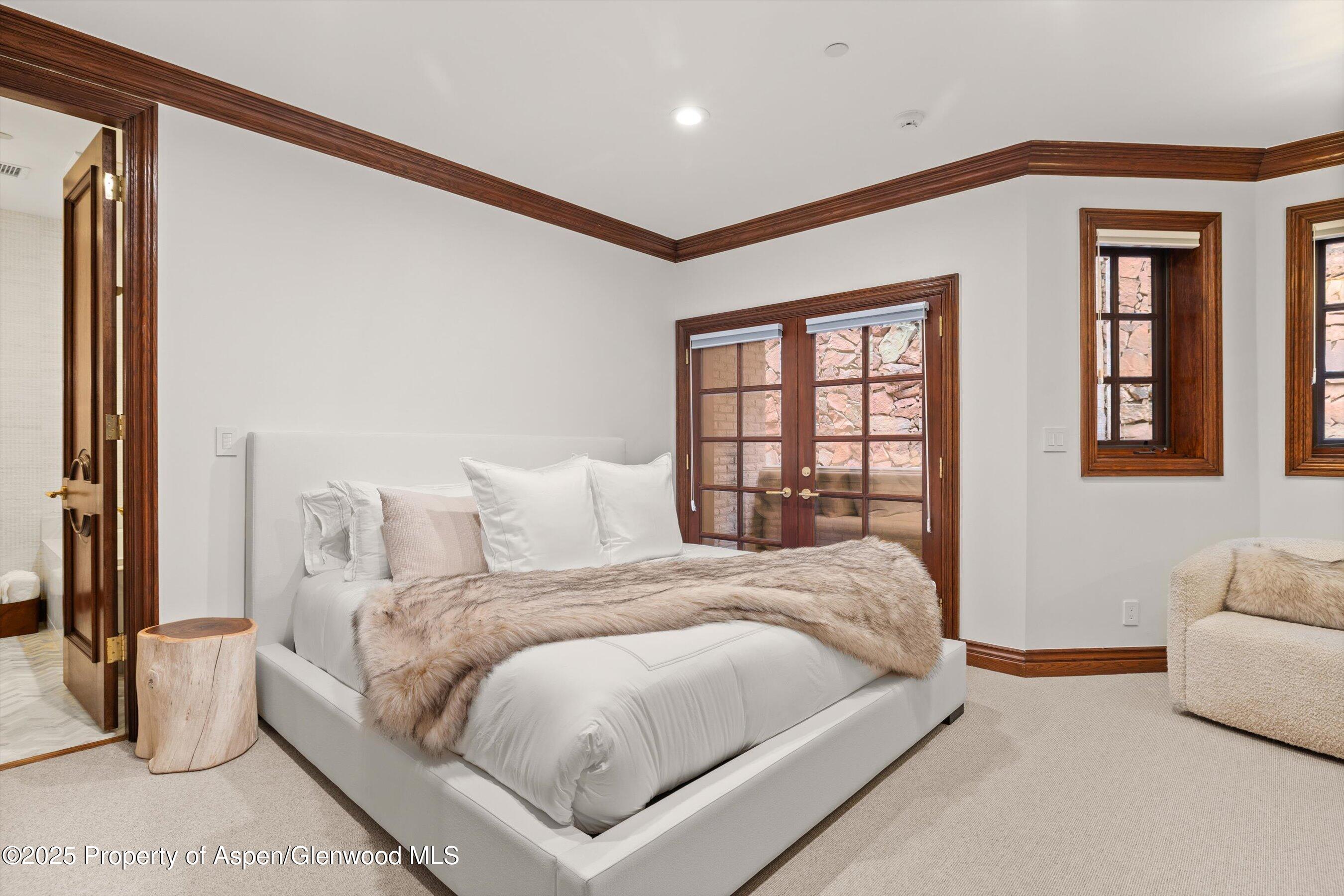 918 South Mill Street, Unit A Aspen, CO 81611 - Photo 25 of 34 a large white bed sitting in a bedroom next to a window