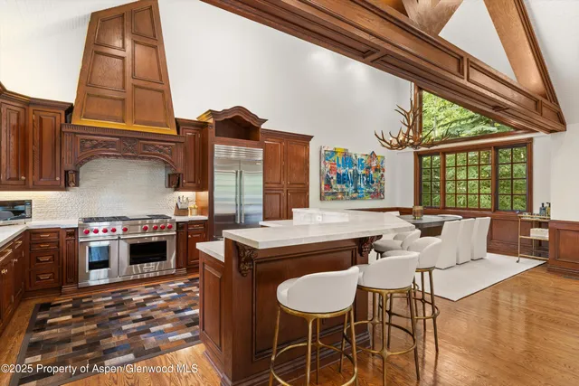 a open kitchen with stainless steel appliances granite countertop a stove and a refrigerator
