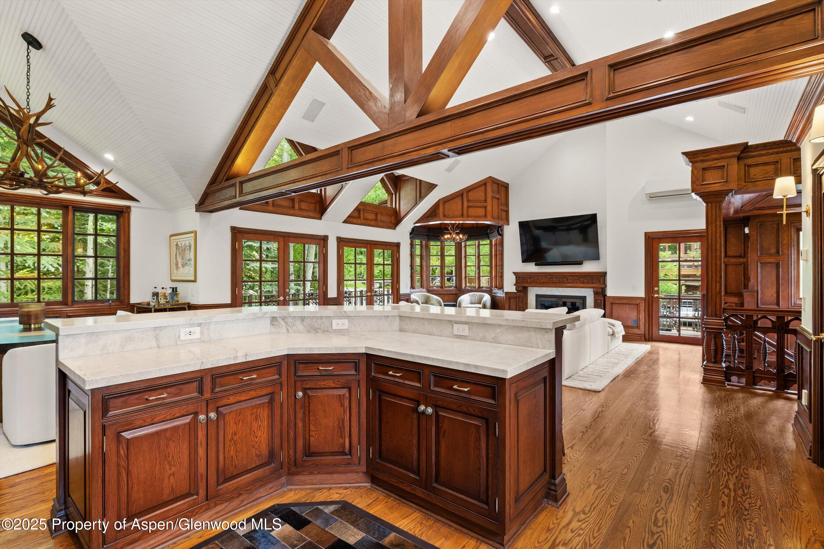 918 South Mill Street, Unit A Aspen, CO 81611 - Photo 6 of 34 a kitchen with stainless steel appliances granite countertop a stove and a wooden cabinets