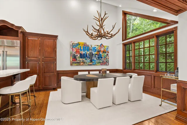 a living room with furniture and wall paintings