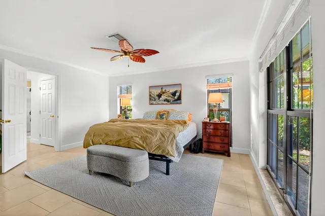 a bedroom with a bed and ceiling fan