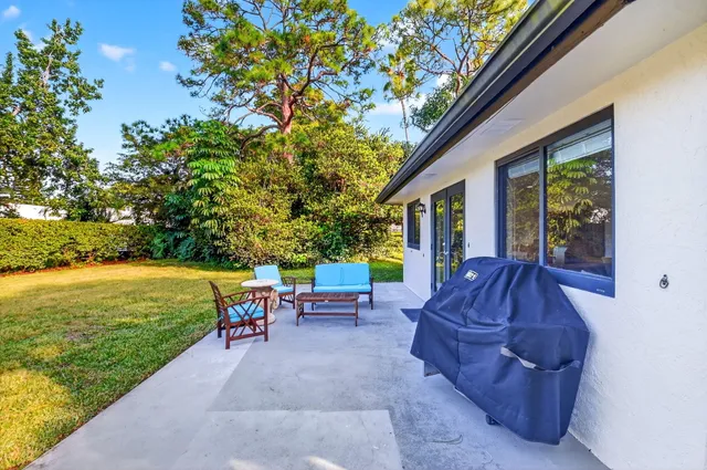 a aerial view of a house with a yard table and chairs