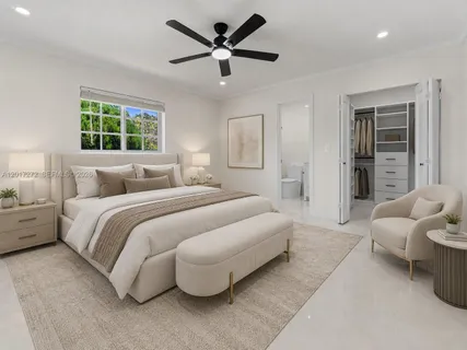 a bedroom with a bed and glass window
