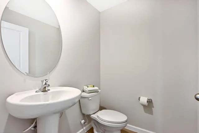 a bathroom with a sink a mirror and a toilet