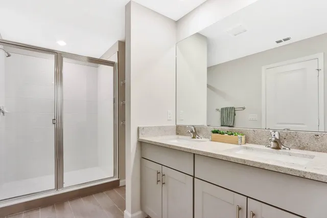 a bathroom with a double vanity sink and mirror