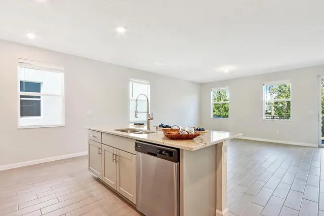a kitchen with a sink window and cabinets
