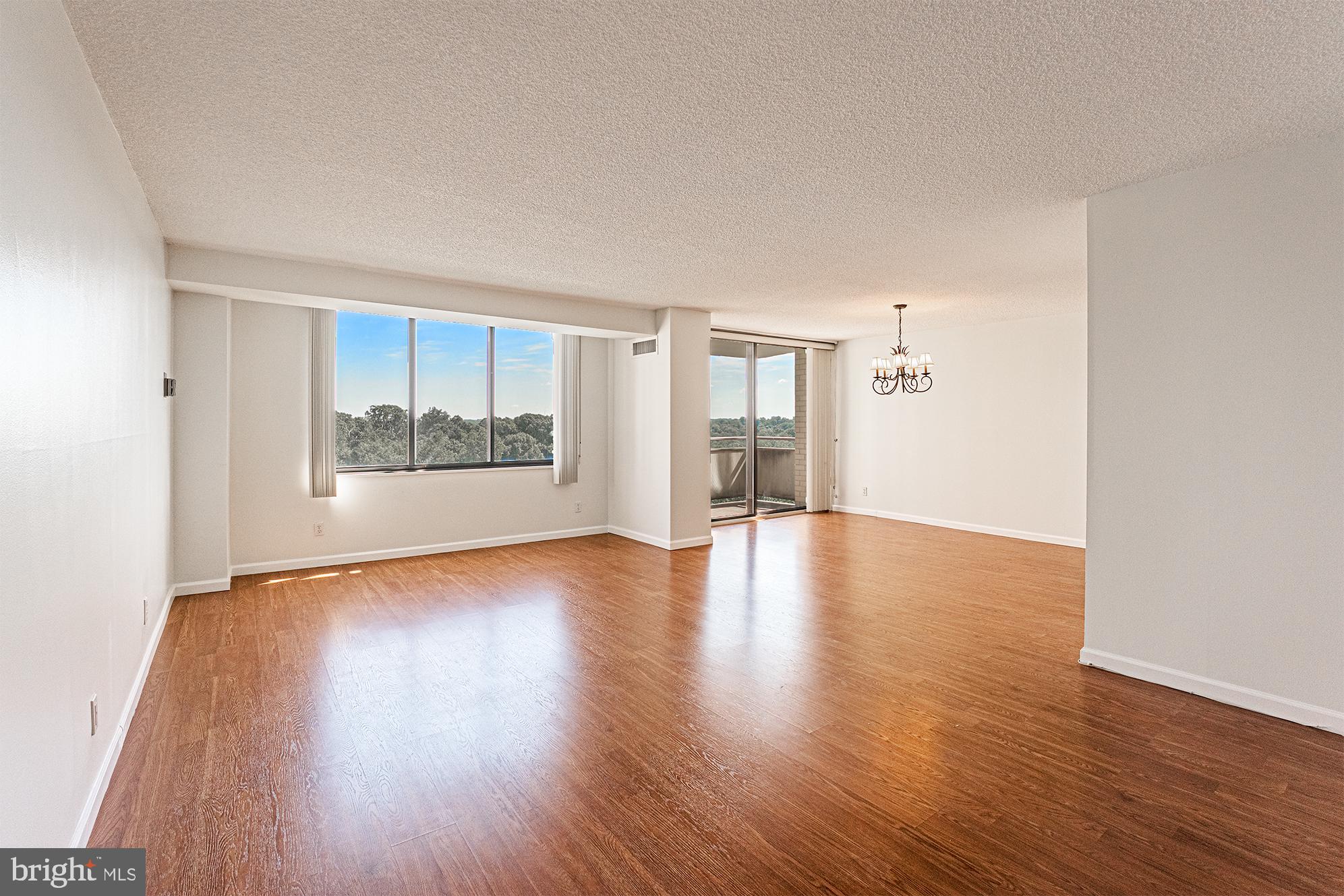 5225 Pooks Hill Road, Unit 721S Bethesda, MD 20814 - Photo 2 of 22 an empty room with wooden floor and windows