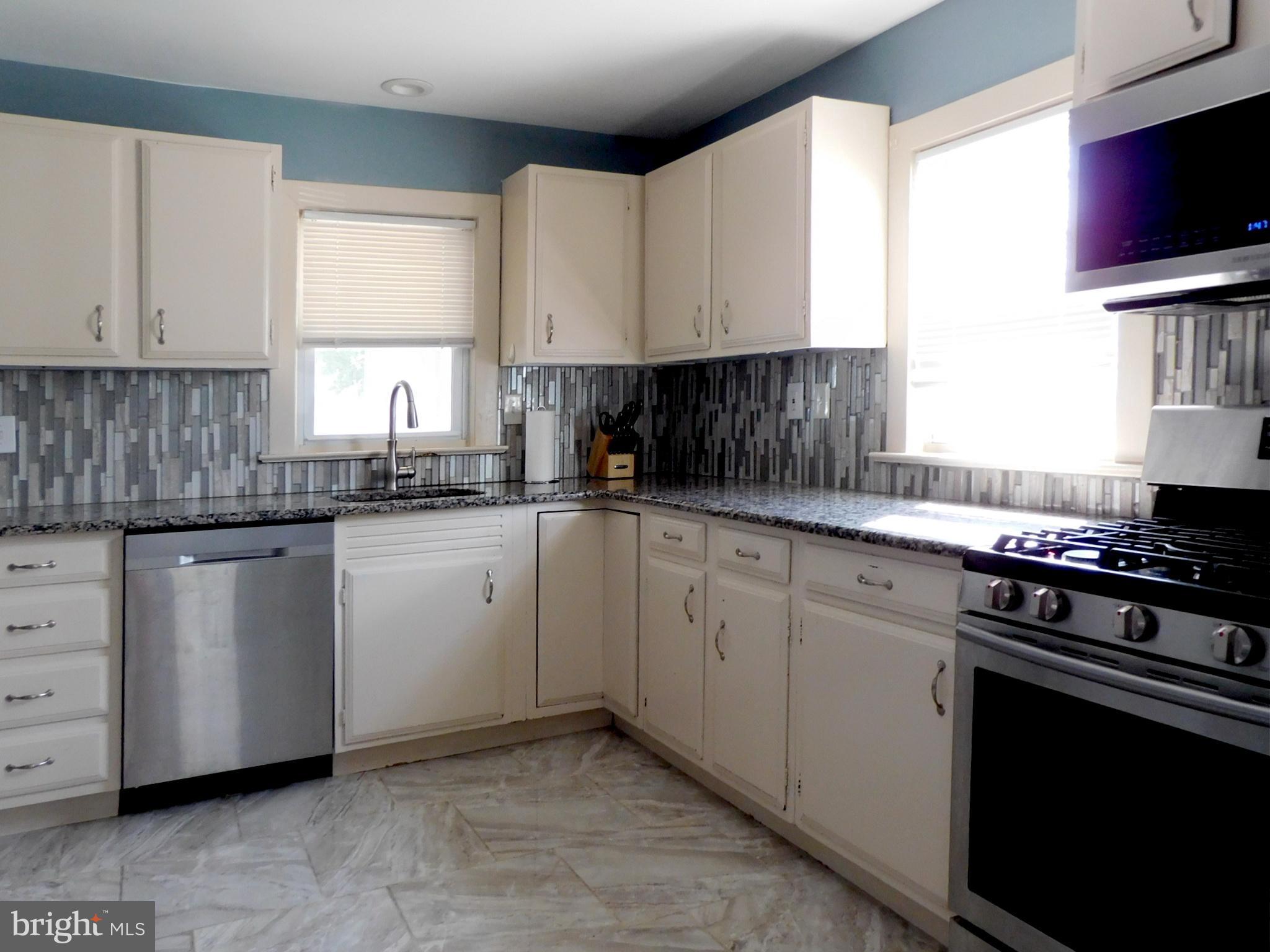 719 Hickory Street Delanco, NJ 08075 - Photo 11 of 29 a kitchen with cabinets appliances a sink and a window