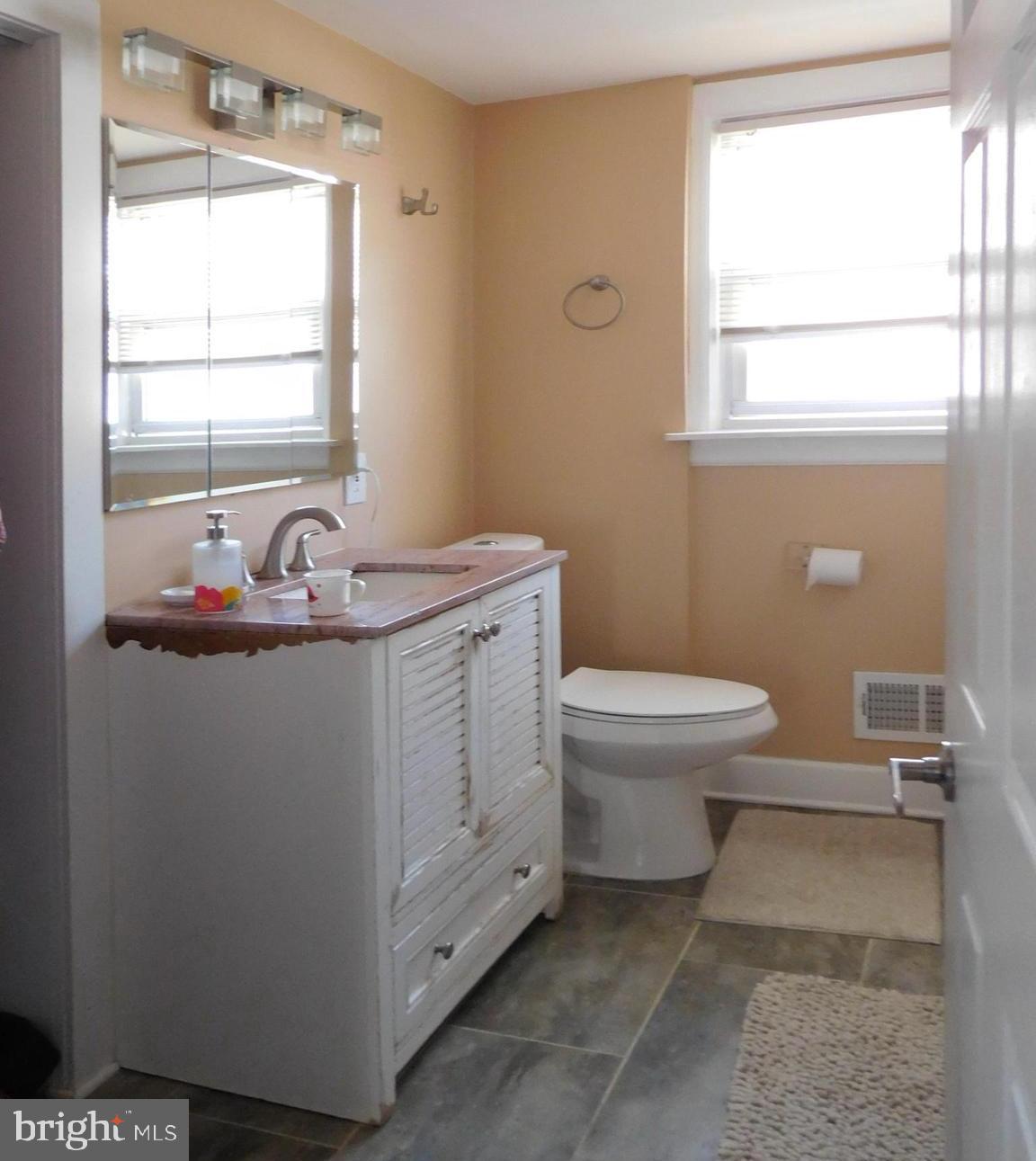 719 Hickory Street Delanco, NJ 08075 - Photo 15 of 29 a bathroom with a sink a toilet and window