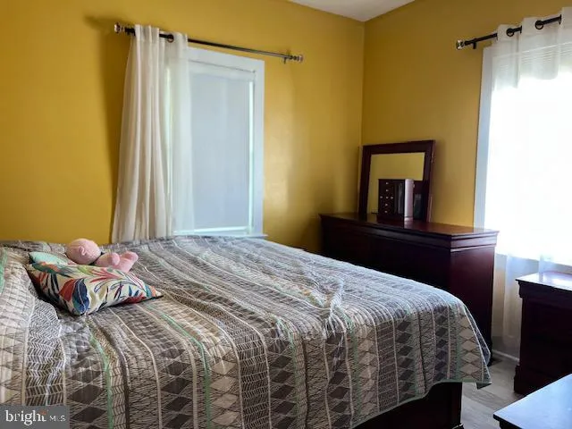 a bedroom with a bed and a dresser