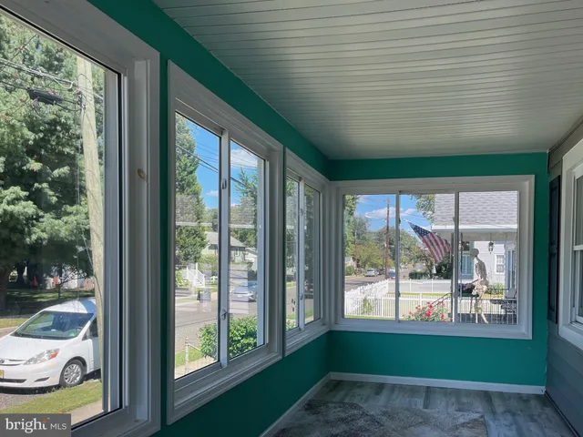 a view of a porch with furniture and garden