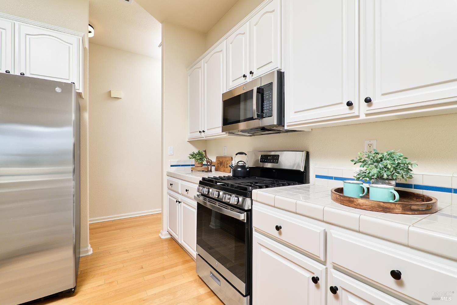 48 Augusta Court Rio Vista, CA 94571 - Photo 12 of 32 a kitchen with stainless steel appliances white cabinets and a stove