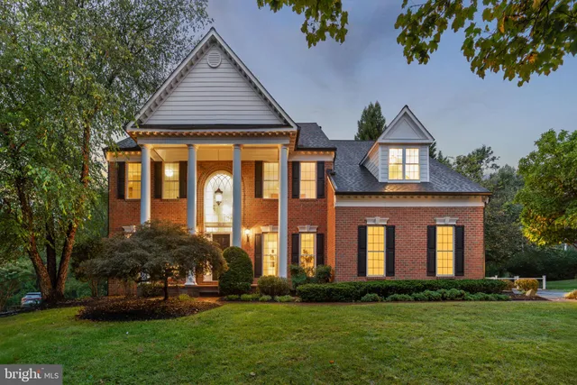 a kitchen with stainless steel appliances granite countertop a sink a stove a refrigerator and island with wooden floor