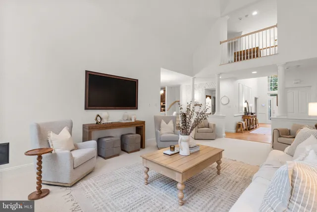 a view of a swimming pool with a yard and large trees