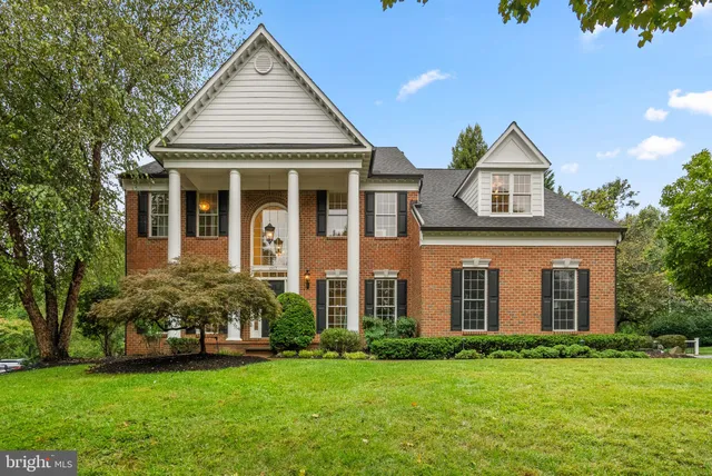 a kitchen with a dining table chairs sink and wooden floor