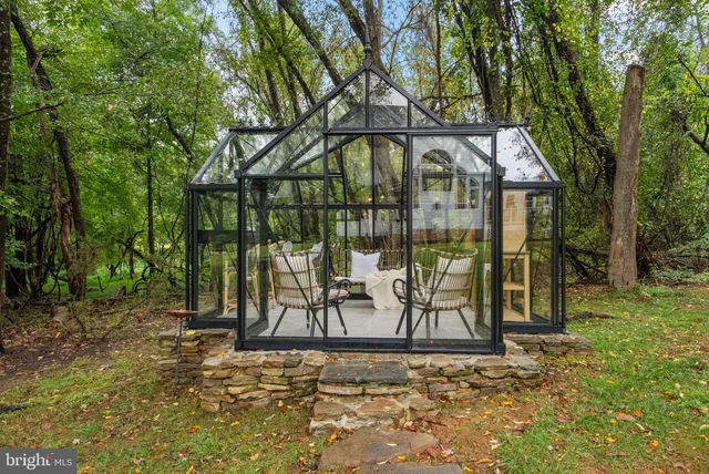 a kitchen with kitchen island a island a stove a refrigerator and a dining table with wooden floor