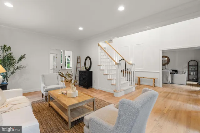 a living room with furniture large window and fireplace